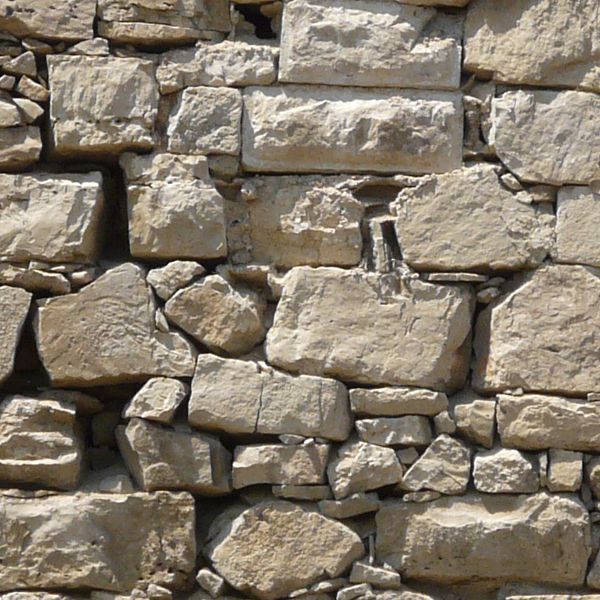 Seamless texture of medieval stone wall consisting of grey stones of various shapes and sizes.