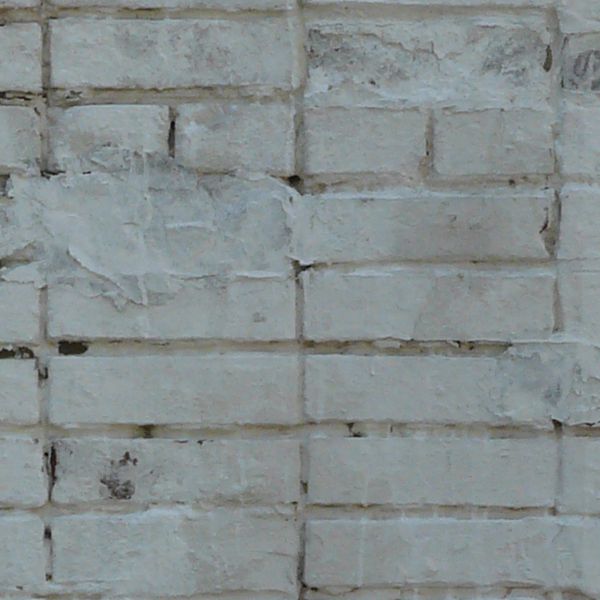 Old grey brick texture with holes and stains on surface.