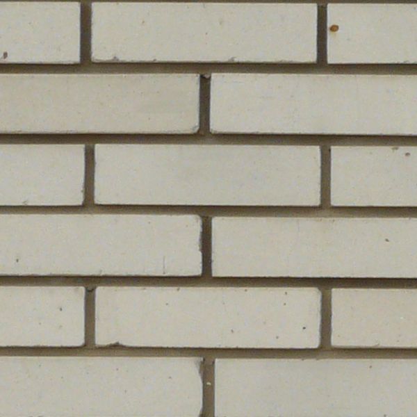 Modern white brick set evenly in dark cement.