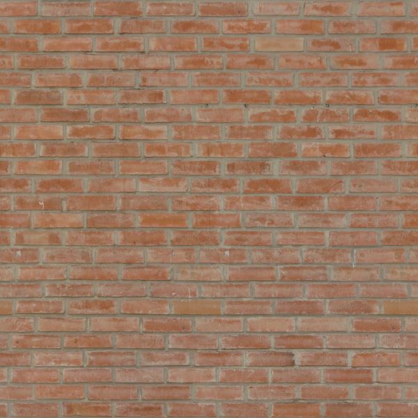 Even red brick wall with light grey spots on surface.