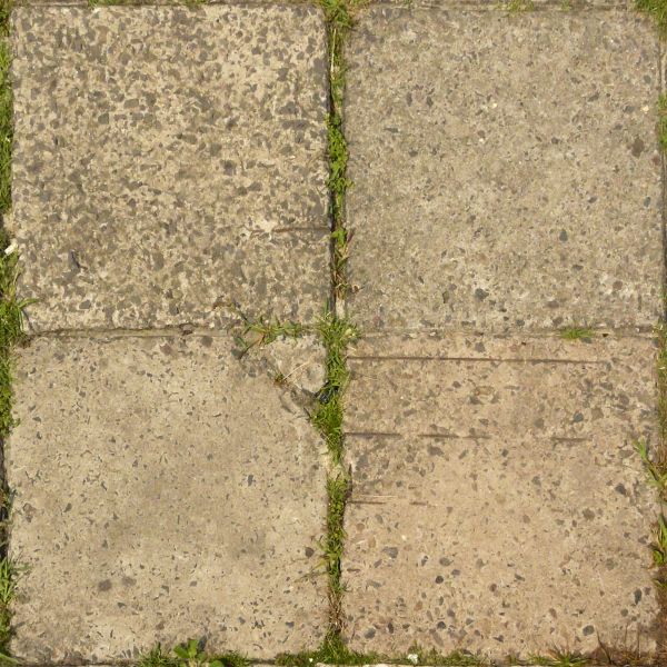 Pavement texture of old, cracked tiles in beige tone with rough surface and vegetation in cracks.