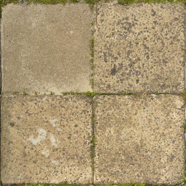 Pavement texture of old, cracked tiles in beige tone with rough surface and vegetation in cracks.