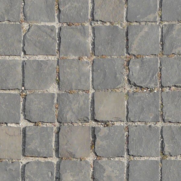 Seamless pavement texture containing small, square tiles in grey tone set evenly in grey cement.