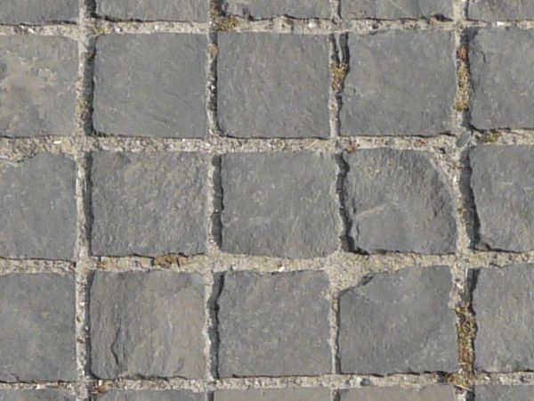 Seamless pavement texture containing small, square tiles in grey tone set evenly in grey cement.