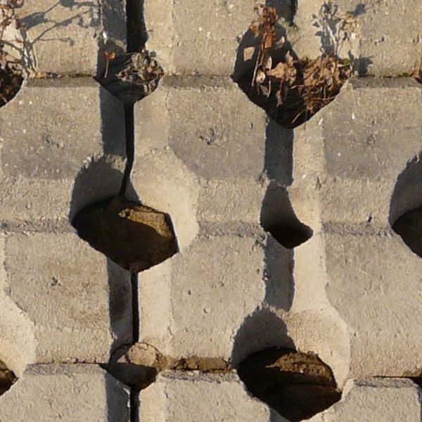 Seamless texture consisting of grey bricks set in repeating pattern with large gaps and holes in between.