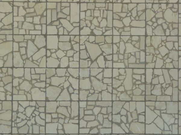 Seamless pavement texture consisting of square tiles made of random pieces of grey slate.