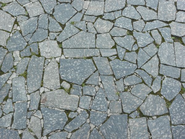 Pavement made of broken stone tile pieces and installed in crazy formation.