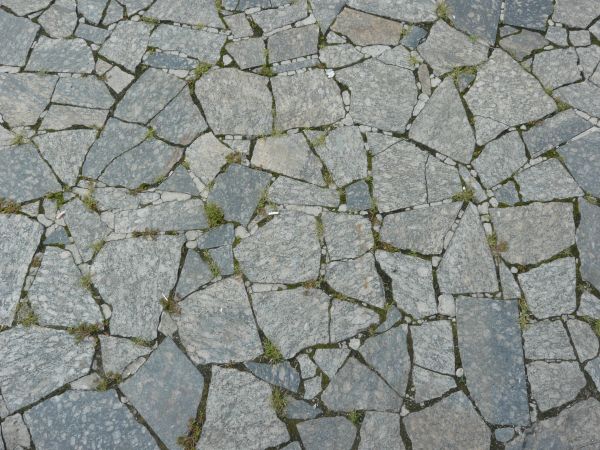 Pavement made of broken stone tile pieces and installed in crazy formation.