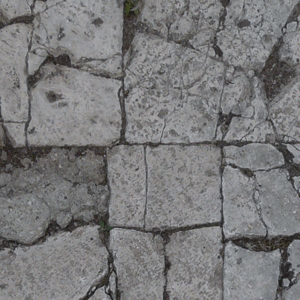 Pavement texture consisting of cracked, rectangular tiles in grey color.