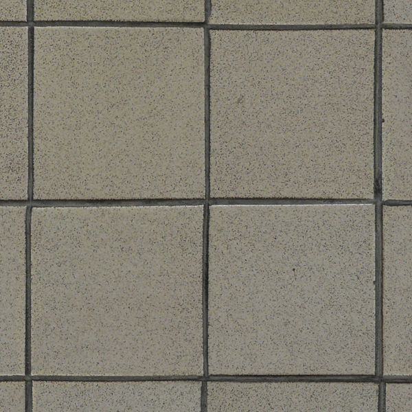 Pavement of square tiles in beige tone set evenly.