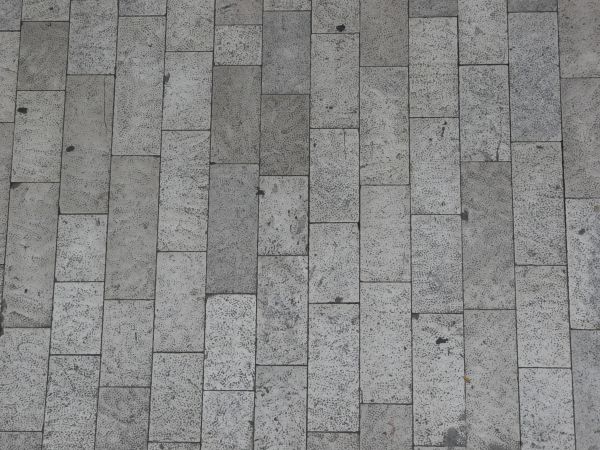 Seamless pavement texture consisting of rectangular stones with rough surface.
