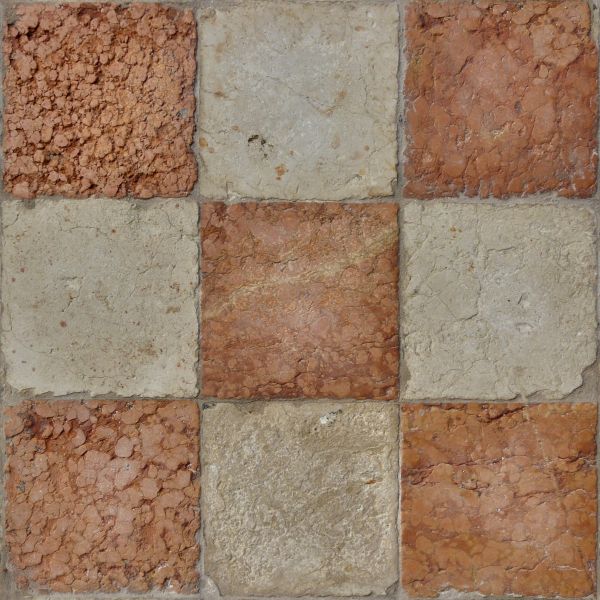 Seamless texture of beige and red, square blocks set evenly with some damage on surface.