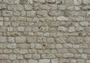 Beige stone set in arrays in wall surface.