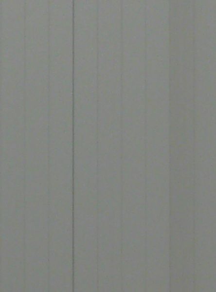 Large building with simple, metal siding painted in alternating, grey tones.