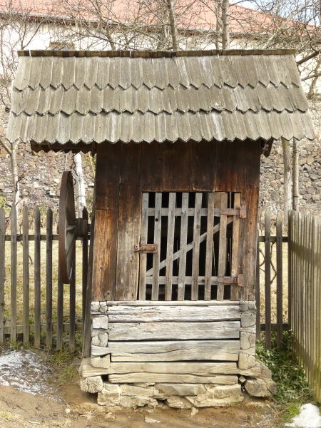 Texture of small shed made of wood with roof made of angled, wooden shingles.