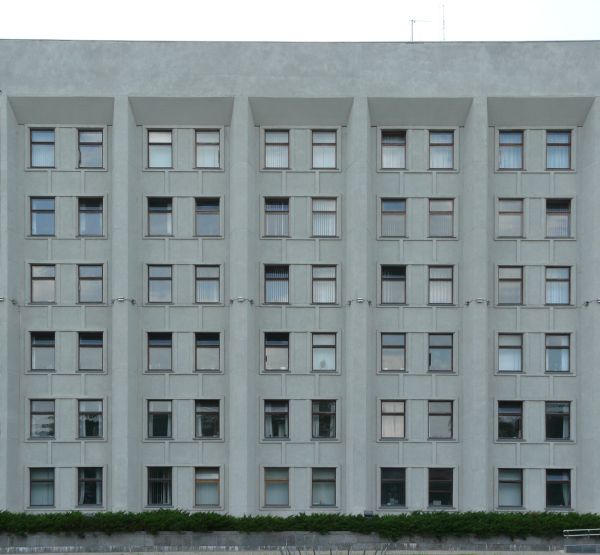 Large, multi-storey building of dull, grey concrete with windows.