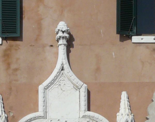 Texture of old building with worn surface and intricately designed trims and frames.