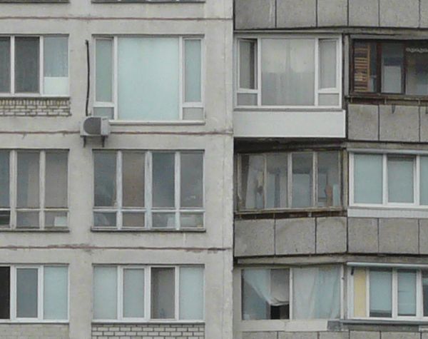 Texture of very old, tall apartment building. Building is many storeys high and with old windows.