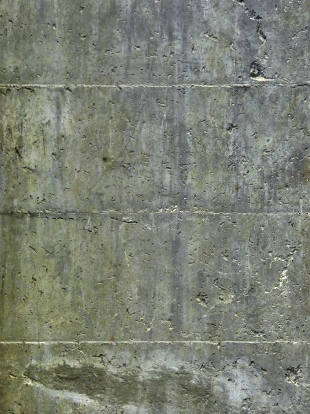 Concrete base texture in dark grey tone with thin, visible seams and random holes in surface.