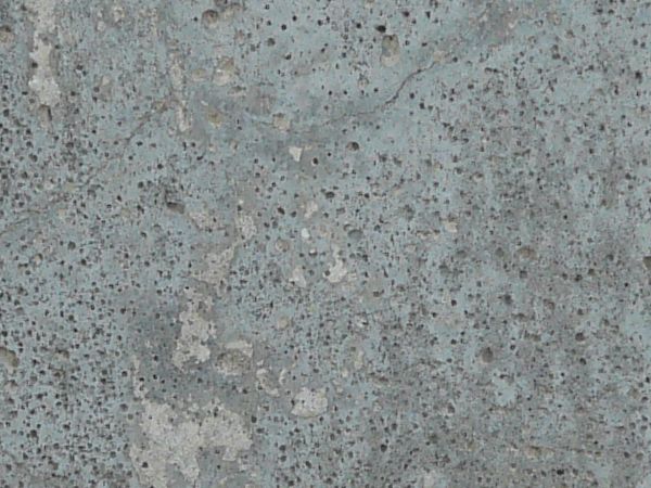 Concrete slab in inconsistent blue-grey tone with small cracks and holes in surface.