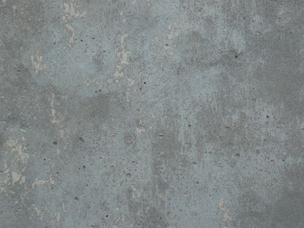 Concrete slab in inconsistent blue-grey tone with small cracks and holes in surface.