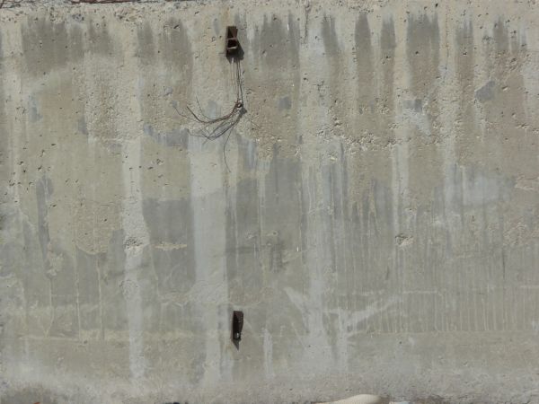 Worn concrete base in light grey tone with light streaks on surface.