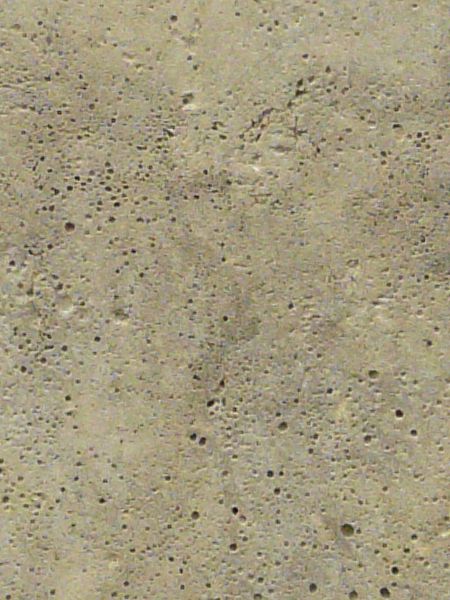 Seamless concrete texture in light beige tone with consistent surface and small holes throughout.