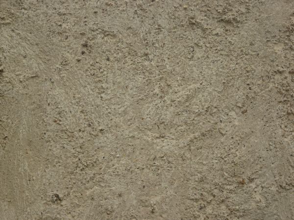 Concrete texture in light brown tone with very rough, irregular surface.