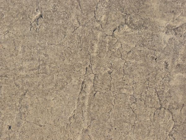Brown concrete texture with rough, inconsistent surface and lines.