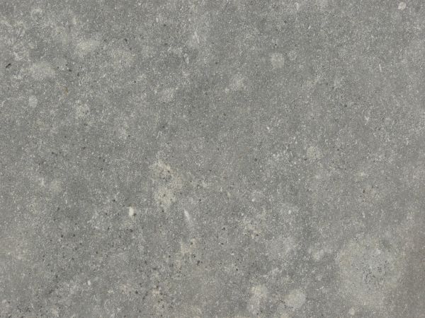 Concrete texture in grey tone with slightly rough surface and light spots.