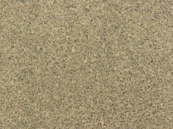 Seamless texture of concrete in light brown color with small stones embedded in surface.
