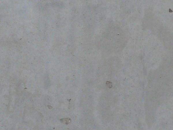 Grey, clean concrete texture with smooth surface and small holes at regular intervals.