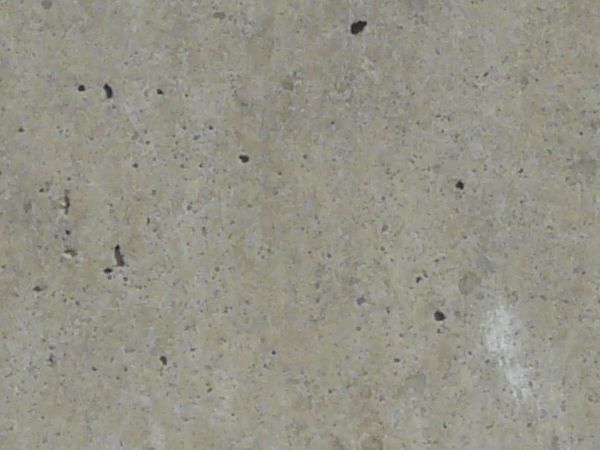 Concrete texture in light grey tone with smooth surface and small holes.