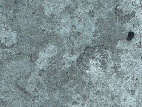 Rough concrete texture in mixed grey tones with irregular surface.