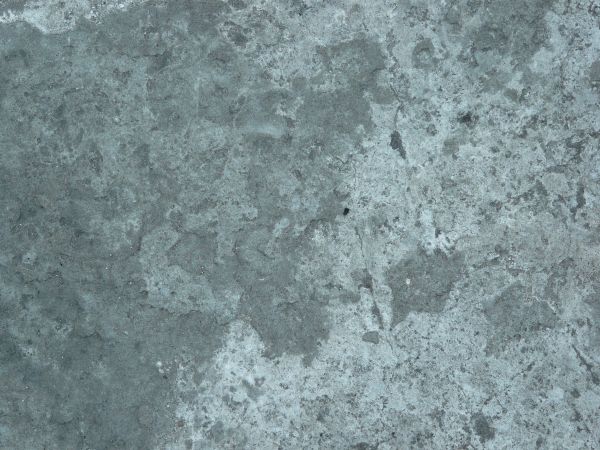 Rough concrete texture in mixed grey tones with irregular surface.