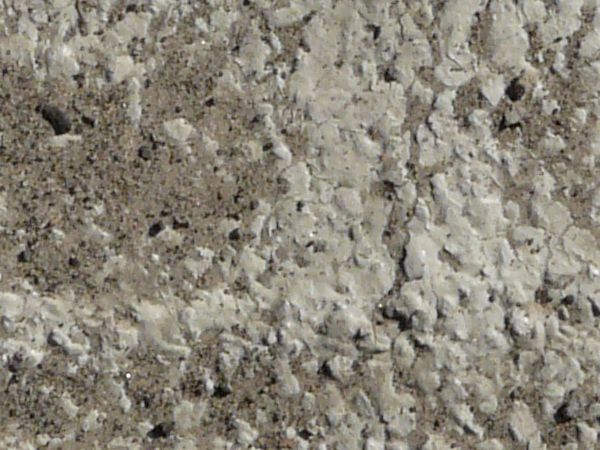 Concrete ground texture in light grey tone with rough surface and dirt.
