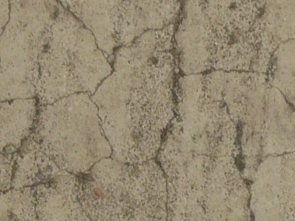 Dirty concrete floor texture in light beige tone with small cracks throughout surface.