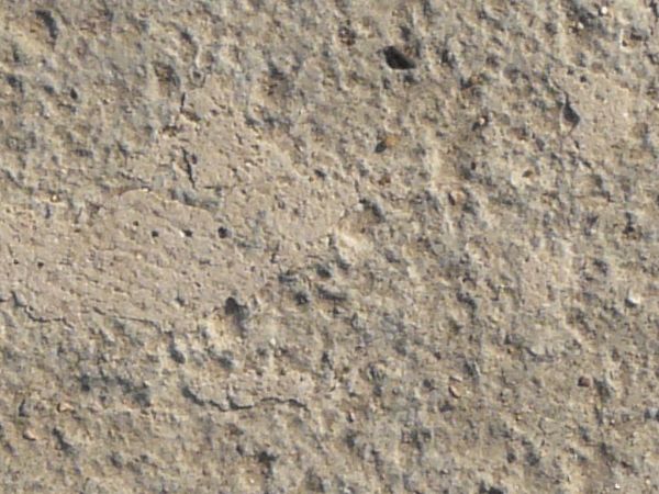 Texture of concrete floor in light beige color with slightly rough, flat surface.