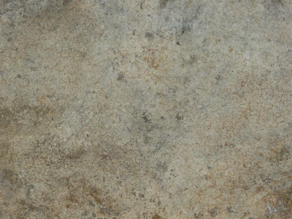 Concrete ground texture in various shades of brown and grey with flat, consistent surface.