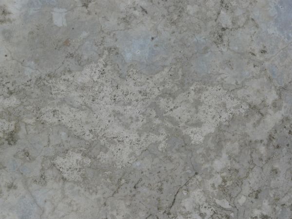 Old concrete floor texture in various tones of grey with few, thin cracks in surface.