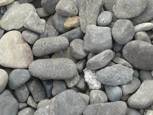 Large grey pebbles texture, mostly with dry and smooth surfaces.