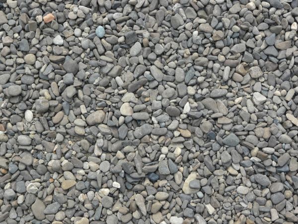 Large grey pebbles texture, mostly with dry and smooth surfaces.