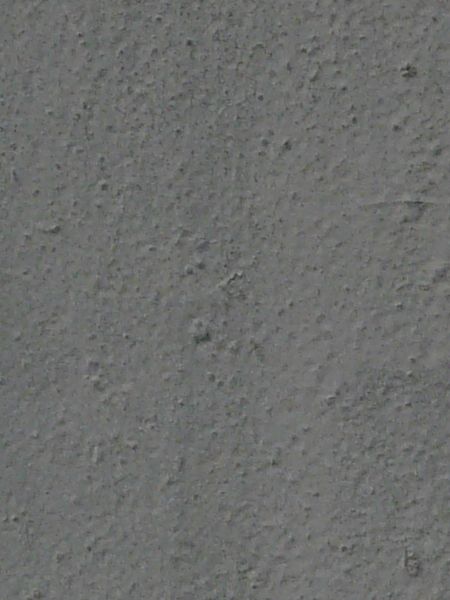 Seamless metal texture in dark grey tone with small bumps and dents.