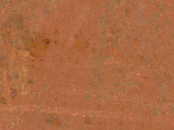 Metal texture painted in red tone with small bumps and scratches on surface.