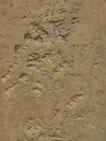 Rough metal texture in bronze color with large dents in surface.