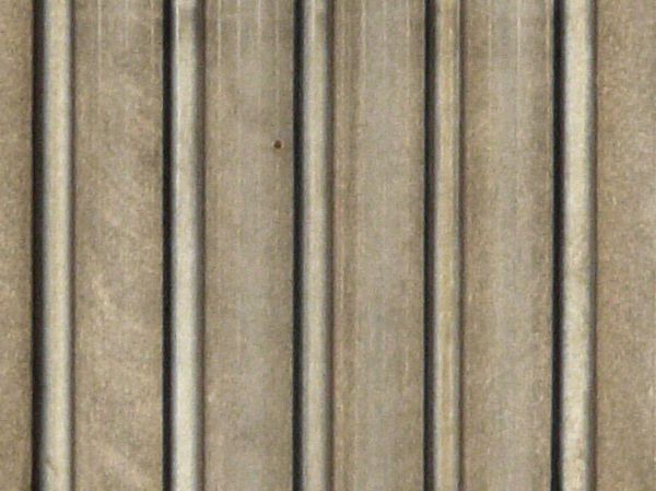 Old metal texture of lined, grey sheets of metal with slightly worn surface.