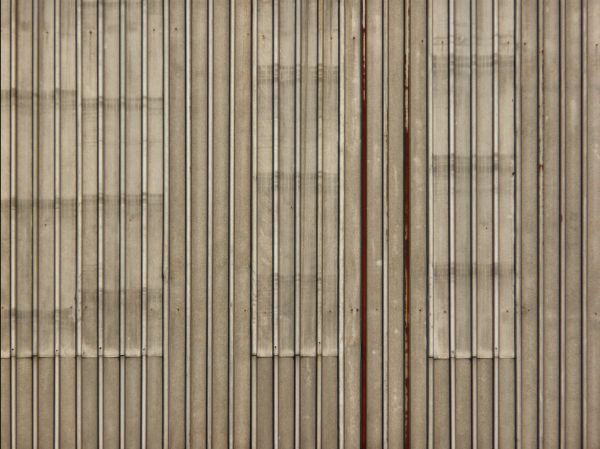 Old metal texture of lined, grey sheets of metal with slightly worn surface.