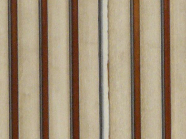 Old metal texture of lined, grey sheets of metal with slightly worn surface.