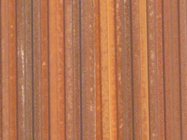 Aluminum siding in brown color with lined texture and slightly worn surface.