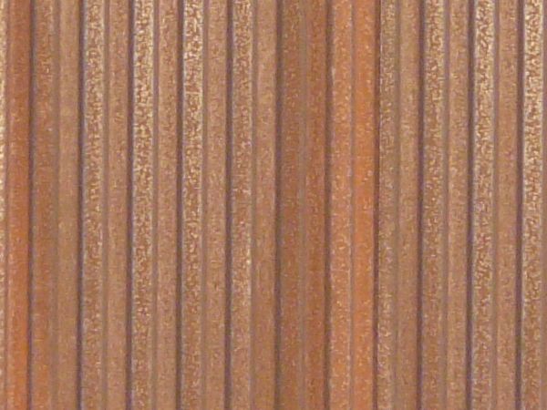 Aluminum siding in brown color with lined texture and slightly worn surface.